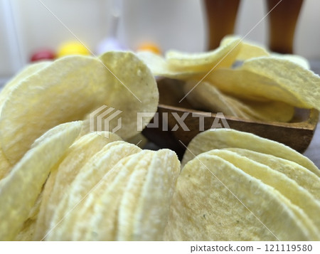 crispy potato chips on a sliced board crispy potato chips on a sliced board 121119580