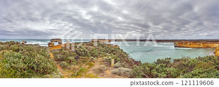 Dramatic coastal cliffs and ocean view near Great Ocean Road with cloudy skies Dramatic coastal cliffs and ocean view near Great Ocean Road with cloudy skies 121119606
