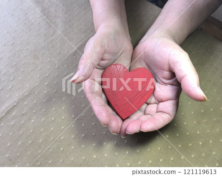scarlet wooden heart in women palms scarlet wooden heart in women palms 121119613