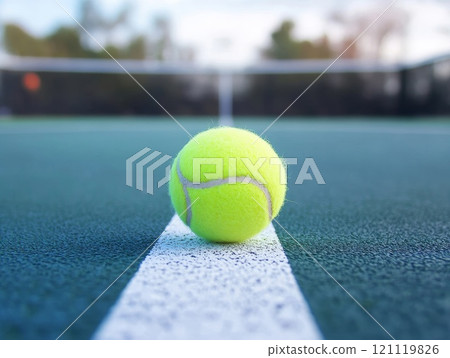 Tennis ball hitting the line on a court. 121119826