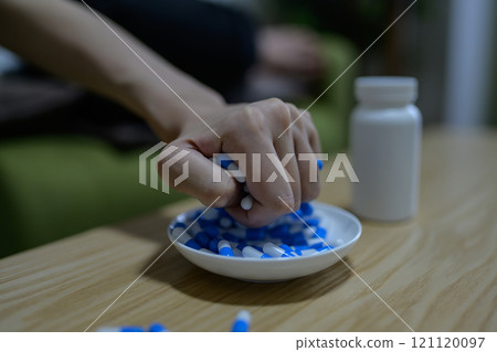 Overdose, OD image, woman taking a large amount of medicine, drug overdose, stress, depression, overtime, fatigue, overwork 121120097