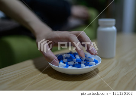 Overdose, OD image, woman taking a large amount of medicine, drug overdose, stress, depression, overtime, fatigue, overwork 121120102