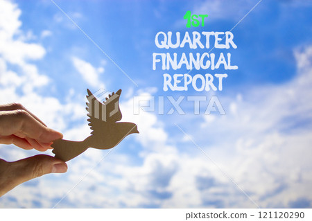 1st quarter financial report symbol. Concept words 1st quarter financial report. Beautiful blue sky and clouds background. Businessman hand. Business 1st quarter financial report concept. Copy space. 121120290