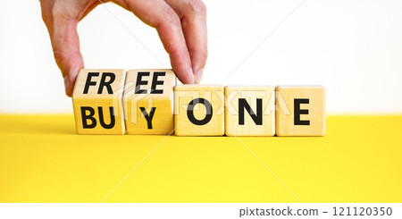 Buy and free one symbol. Businessman turns wooden cubes and changes words Buy one to Free one. Beautiful yellow table white background, copy space. Business Buy and free one concept. Buy and free one symbol. Businessman turns wooden cubes and changes words Buy one to Free one. Beautiful yellow table white background, copy space. Business Buy and free one concept. 121120350