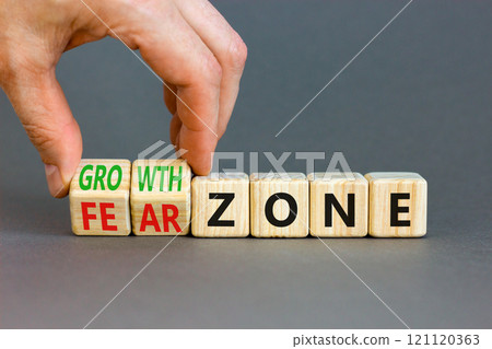 Growth or fear zone symbol. Concept words Growth zone Fear zone on wooden cubes. Beautiful grey table grey background. Psychologist hand. Business and growth or fear zone concept. Copy space. 121120363