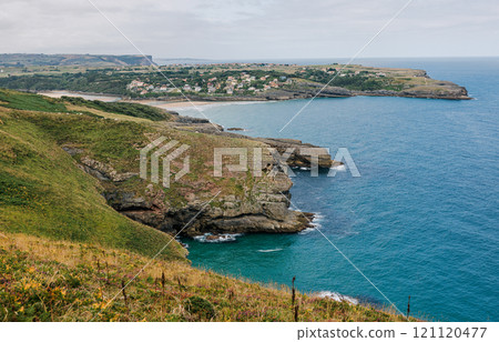 A scenic coastal landscape with rugged cliffs 121120477