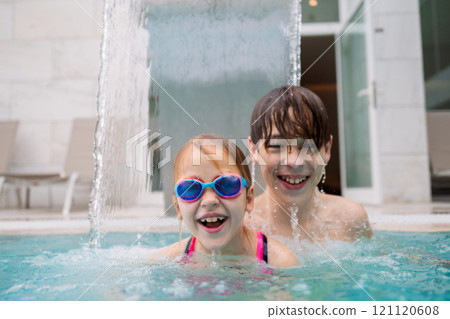 Happy siblings under water stream Happy siblings under water stream 121120608