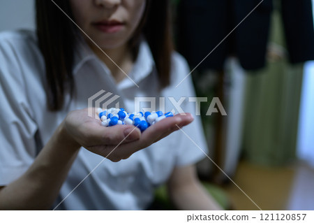 Overdose, OD image, woman taking a large amount of medicine, drug overdose, stress, depression, overtime, fatigue, overwork 121120857