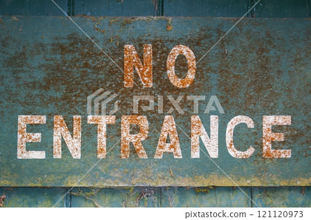 Old inscription NO ENTRANCE on a blue background. Fragment of old dirty sign. 121120973