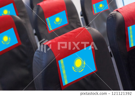 Kazakhstani Flag on Empty seat in plane. Travel, flight and transportration in Kazakhstan concept Kazakhstani Flag on Empty seat in plane. Travel, flight and transportration in Kazakhstan concept 121121392