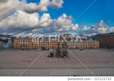 Senate Square in Helsinki, Finland, features the Alexander II statue, surrounded by neoclassical buildings like the Government Palace under dramatic clouds. 121121710