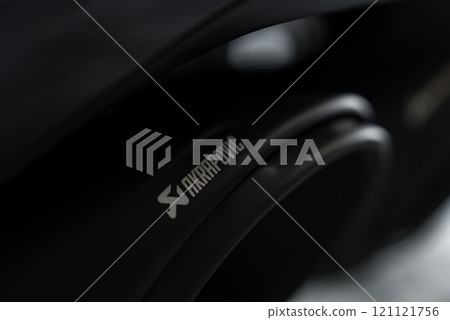 The image shows a detailed view of an Akrapovic exhaust system with a sleek, dark metallic finish, emphasizing its high performance branding. The image shows a detailed view of an Akrapovic exhaust system with a sleek, dark metallic finish, emphasizing its high performance branding. 121121756