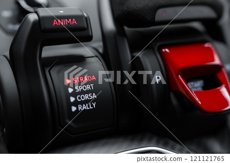The image captures the driving mode selector in a Lamborghini Urus Performante, highlighting the 'Strada' mode in red. Black and red accents adorn the interior. 121121765