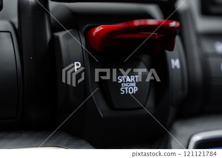The image features a close up of the Lamborghini Urus Performante's start or stop engine button with a red cover, surrounded by sleek and modern controls. 121121784