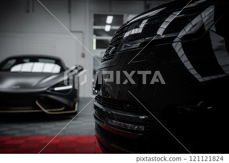 The image shows a Lamborghini Urus and McLaren 720S in a showroom, highlighting the Urus's angular headlights and the McLaren's aerodynamic design. 121121824