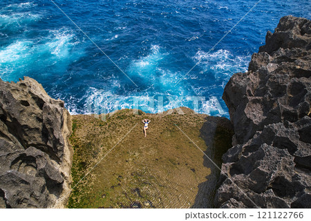 A cliff broken by an ocean wave. The cliff is washed by powerful waves of the ocean. A popular tourist destination Angel's Billabong on the island of Nusa Penida in Indonesia. 121122766
