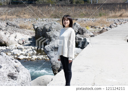 A woman standing on a submerged bridge at Inuishi Inubashiri A woman standing on a submerged bridge at Inuishi Inubashiri 121124211