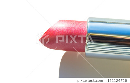 Close-up of a part of a golden tube of lipstick on a white background 121124726