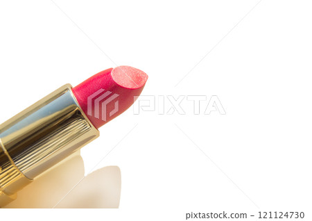 Close-up of a part of a golden tube of lipstick on a white background Close-up of a part of a golden tube of lipstick on a white background 121124730