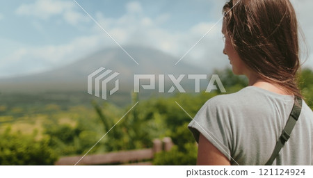 Woman enjoy view on Legazpi Mountains Volcano, Philippines. Asia wild nature tropical landscape. Tourist female relax, outdoor lifestyle travel on summer holiday vacation. Back view, Woman enjoy view on Legazpi Mountains Volcano, Philippines. Asia wild nature tropical landscape. Tourist female relax, outdoor lifestyle travel on summer holiday vacation. Back view, 121124924