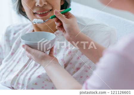Senior woman living in a nursing home and a young caregiver 121126601