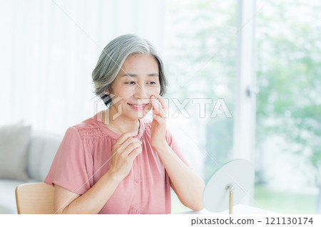 Senior woman doing skin care Senior woman doing skin care 121130174