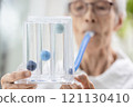 Asian senior woman using incentive spirometer,tool to help the lung expansion,exercise the lung,old elderly with chronic obstructive pulmonary disease,problem of respiratory system,health care,medical 121130410