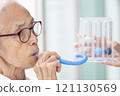 Asian senior woman using incentive spirometer,check her lung,pulmonary function test,measuring the air capacity of lungs,breathing,taking air into and expelling it from the lungs,healthcare,medical 121130569