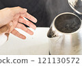 Hands with burning pain from scalding heat water,boiling water and hot steam in the electric kettle spilled onto skin of her hand,girl suffering harm and injury,scald blister,accident at home 121130572