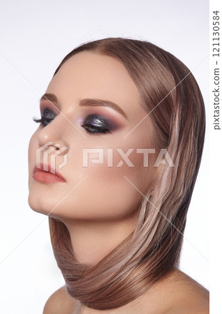 Beautiful Woman with an Fashion Hairstyle and Creative Makeup. Beauty face with trendy Make-up 121130584
