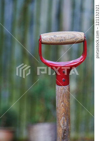 Closeup of a shovel handle in an empty garden, reqady to be used with copyspace. Zoom in on wooden patterns and texture of a gardening tool with copy space. Garden cleanup made easier with a gadget 121132321