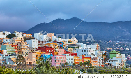 Colorful buildings in Santa Cruz de La Palma with copy space. Beautiful cityscape with bright colors mountains and overcast clouds. A vibrant holiday or vacation destination on the hillside 121132341