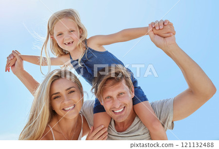 Portrait of a happy family having fun together with copyspace. Young smiling parents enjoying quality time with their little daughter, relaxing and being playful while on a summer beach vacation 121132488