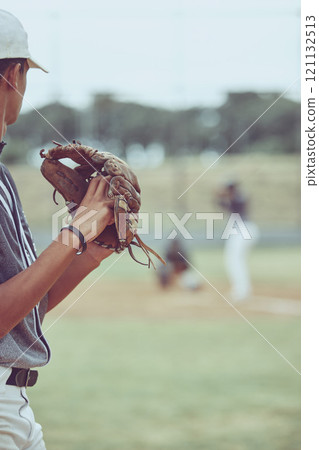 Closeup of a pitcher playing a baseball match. Sports player in action about to throw the ball to a batter. Competitive athlete at a game of baseball in a stadium between two teams 121132513