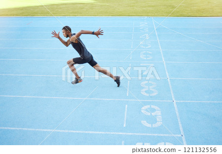 Athlete running on track during competitive training practice. Full length athletic, fit, active male runner sprinting with speed in sports centre. Exercising cardio health and stamina in workout 121132556