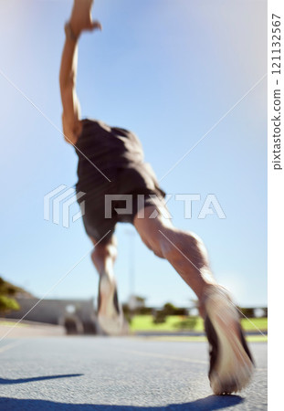 Athlete running on a sports track for fitness exercise in outdoor training practice. Below view of fit active man sprinting motion blur speed. Runner performing cardio workout for health and stamina Athlete running on a sports track for fitness exercise in outdoor training practice. Below view of fit active man sprinting motion blur speed. Runner performing cardio workout for health and stamina 121132567