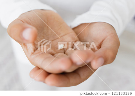 Close-up of young child holding baby tooth in hands. Caucasian child demonstrating curiosity and innocence. Symbol of growth and childhood milestones. Close-up of young child holding baby tooth in hands. Caucasian child demonstrating curiosity and innocence. Symbol of growth and childhood milestones. 121133159