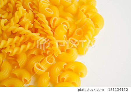Pasta noodles for cooking Italian food in plastic bag on white background. 121134150