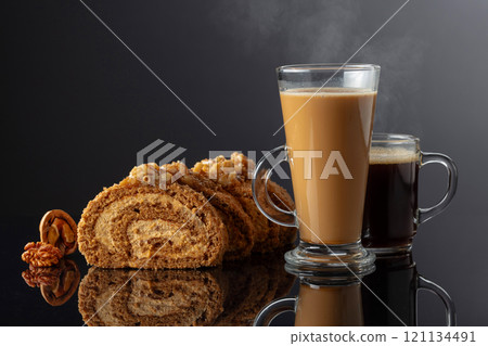 Dessert with walnuts and coffee on a black reflective background. Dessert with walnuts and coffee on a black reflective background. 121134491