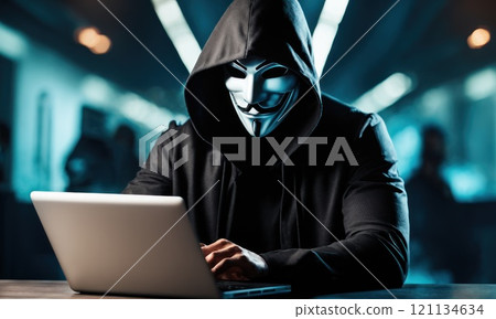 A man in mask with hood behind laptop. Symbol of group of hackers and anti system uprising against governments. Obscured dark face using computer for cyber attack, Data thief, internet attack. AI 121134634