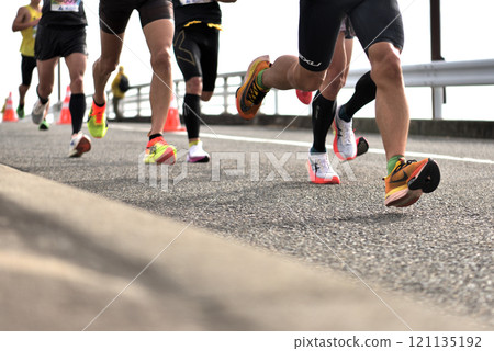 Marathon: A marathon runner running up a hill 121135192