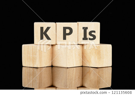 Business strategists. Copy space. The abbreviation KPIs made of wooden cubes on a black background Business strategists. Copy space. The abbreviation KPIs made of wooden cubes on a black background 121135608
