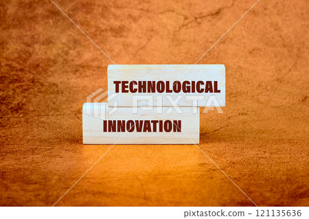 Words depicting technological innovation on wooden blocks against a textured orange background emphasizing creativity and progress 121135636