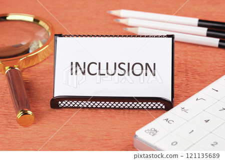 Business concept. The conceptual phrase INCLUSION written on a business card standing in a stand 121135689