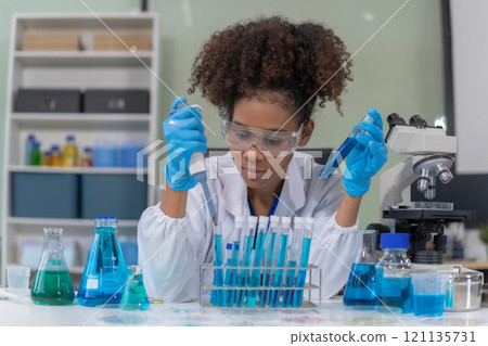 Scientist mixing chemical liquids in the chemistry lab. Researcher working in the chemical laboratory. Scientist mixing chemical liquids in the chemistry lab. Researcher working in the chemical laboratory. 121135731
