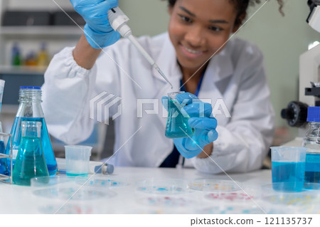 Scientist mixing chemical liquids in the chemistry lab. Researcher working in the chemical laboratory. 121135737