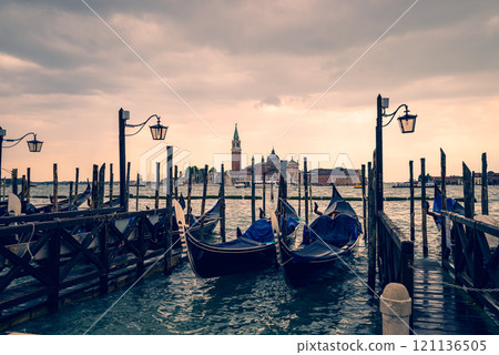 Gondolas and San Giorgio Maggiore Island at sunset Gondolas and San Giorgio Maggiore Island at sunset 121136505
