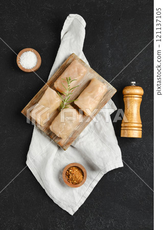 Deliciously wrapped cabbage spring rolls on a wooden board with herbs and spices Deliciously wrapped cabbage spring rolls on a wooden board with herbs and spices 121137105