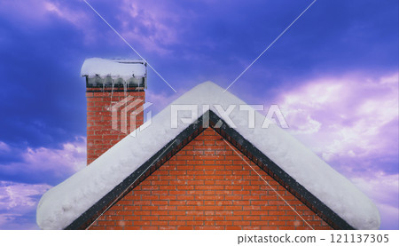 Roof and brick chimney covered with snow in winter 121137305