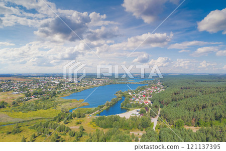 Spring rural landscape in summer. Aerial view. Panoramic view of the village and lake on a sunny day 121137395